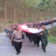 HUT RI ke-79, Polresta dan Kodim Bandar Lampung Kirab Bentangkan Bendera Merah Putih 79 Meter di Bukit Aslan